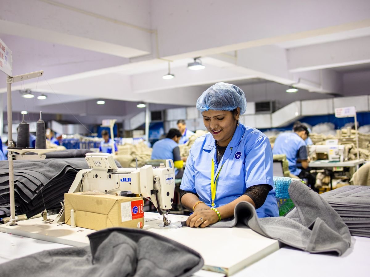 Garment workers at sewing machines in a textile factory