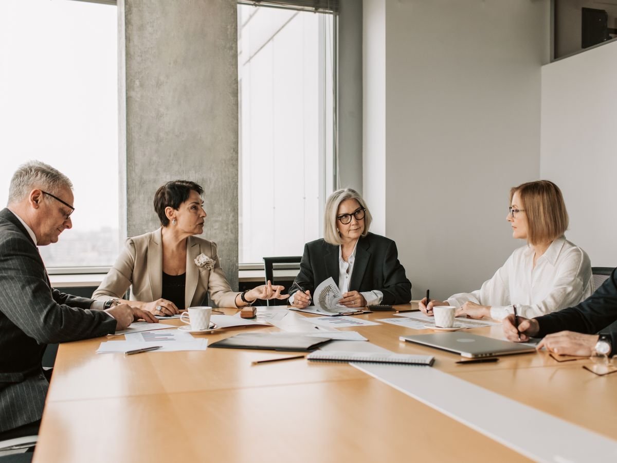 Team reviewing documents around a meeting table